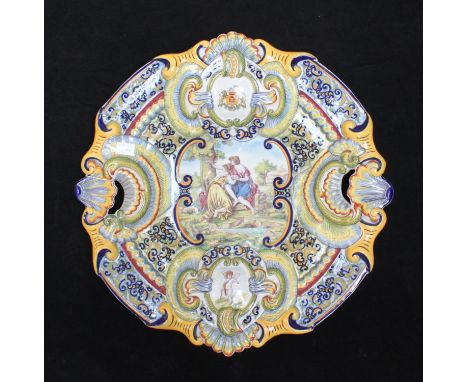 A 19th century large Majolica charger of cartouche form with shell handles, decorated in polychrome enamels with allegorical 