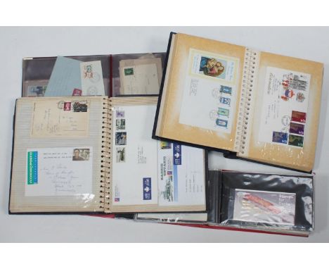 A collection of assorted stamp covers across three albums comprising George VI and QEII examples, together with an album of F