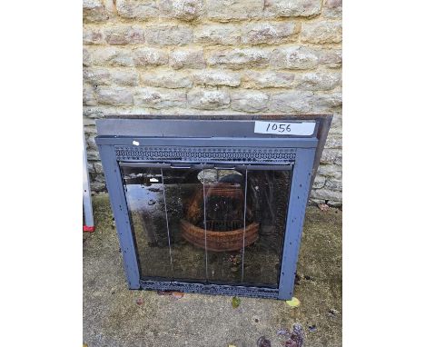 Cast iron fire surround and grate compete with glass doors