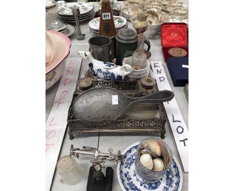 A silver and tortoiseshell hand mirror, an electroplate inkstand, a metronome, a pharmacy bottle, etc.