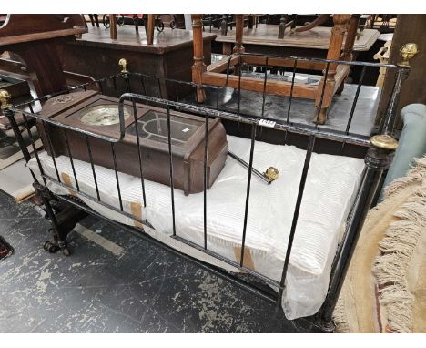 A Victorian iron and brass cot bed. 