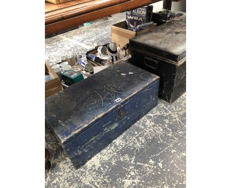 A wooden tool box together with a black metal trunk