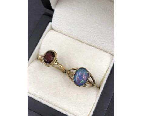 Two 9ct hallmarked gold dress rings, a garnet and an opal. Finger sizes O and M. Gross weight 4.4 grams.