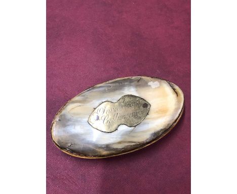 A 19th-century horn snuff box.