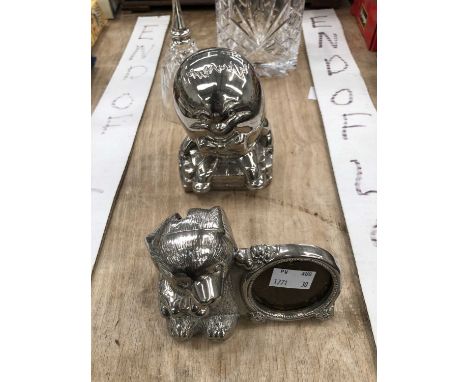 A mantel clock, two chromed money boxes, a glass bell and a spirit decanter