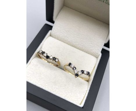 Two 9ct hallmarked gold sapphire and cz wishbone half eternity rings.Finger sizes R and M. Gross weight 3.2 grams. 