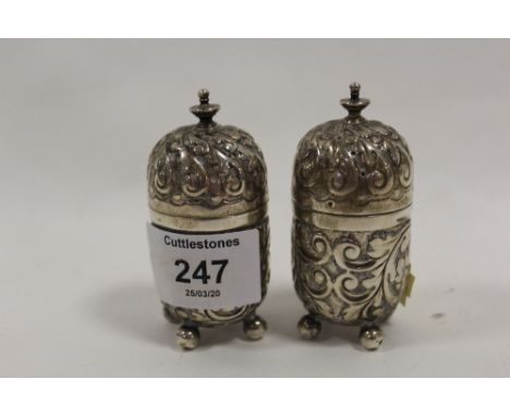 A PAIR OF HALLMARKED SILVER ORNATE PEPPERETTES