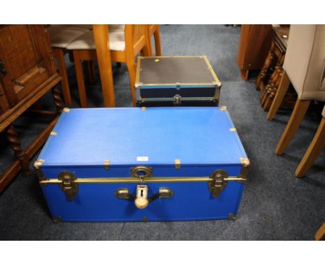 A BLUE PACKING TRUNK AND A SMALLER BLACK TRUNK (2)
