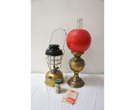 TILLEY STORMLIGHT
model X246B, with instructions, together with a gilt brass oil lamp with an opaque glass shade (2) 
