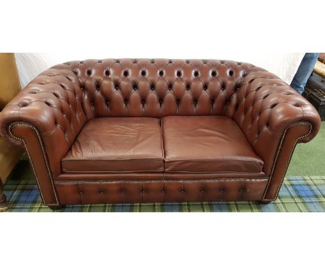 CHESTERFIELD TWO SEAT SOFA
in brown leather with a button back and arms with decorative stud detail, on castors, 172cm wide 