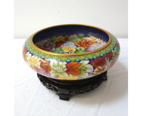 CHINESE CLOISONNE CENTRE BOWL
decorated with colourfull flowers on a circular hardwood stand, 23cm diameter 