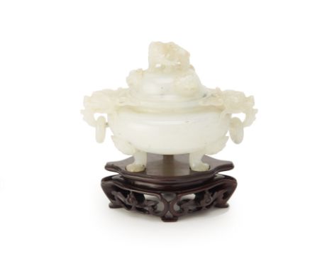 A CHINESE CARVED WHITE JADE CENSER AND COVER
The cover with elephant finial above mask decoration, twin dragon head drop ring