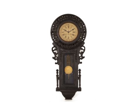 AN ANSONIA REGULATOR WALL CLOCK
Early 20th Century
With Roman numeral chapter ring and outer calendar ring, carved and pierce
