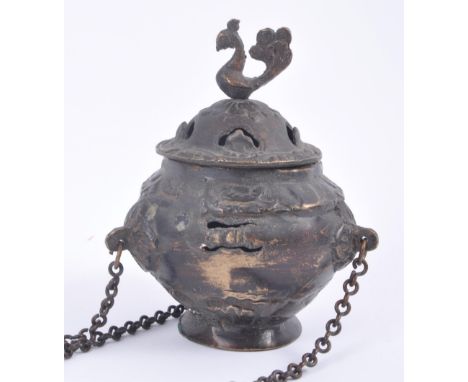 An eighteenth century Middle Eastern / Persian hanging brass incense burner with lid featuring cockerel finial, stylised flor
