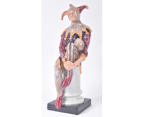 Royal Doulton – The Jester - HN2016 – a hand painted ceramic figure / figurine of a court Jester seated on a column plinth. M