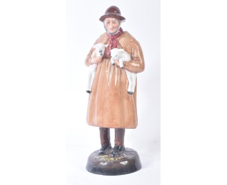 Royal Doulton – Lambing Time -  HN1890 – a hand painted ceramic figure / figurine of a farmer in smock holding lambs. Maker’s