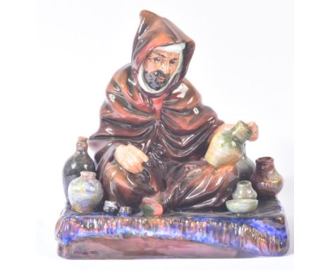 Royal Doulton – The Potter - HN1493 – a hand painted ceramic figure / figurine of a seated robed potter at work, with a colle