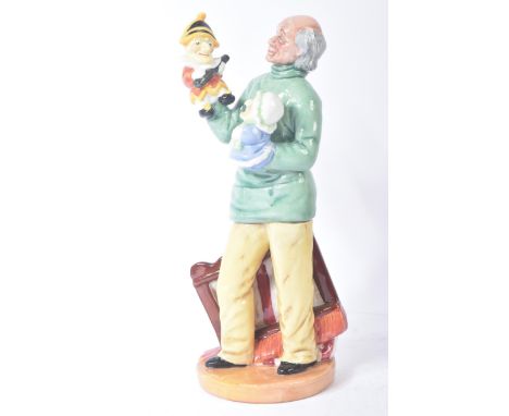 Royal Doulton – Punch & Judy Man (1980) - HN2765 - a hand painted ceramic figure / figurine of a standing man holding both Pu