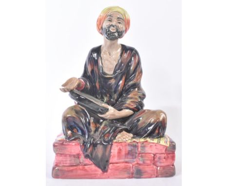 Royal Doulton – Medicant – HN1365 – a hand painted ceramic figure / figurine of a seated religious figure on plinth. Early Ma