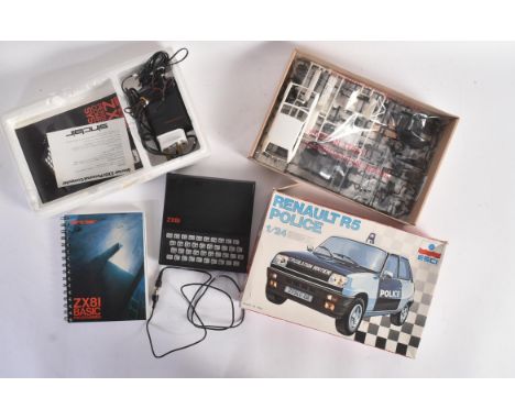 A vintage Sinclair ZX8I home computer with basic programming instruction manual and power outlet along with an Italian ' Esci