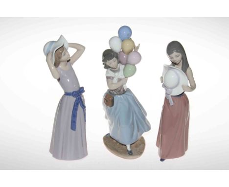 Three Lladro ornaments including Girl with Balloons and two Ladies with Hats.