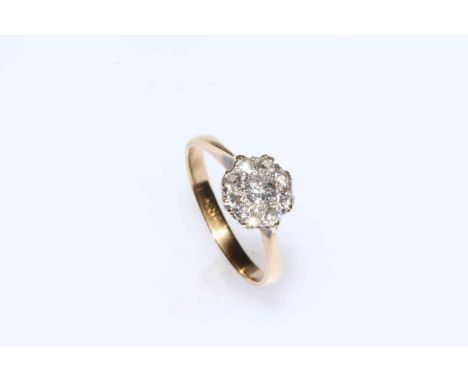 Nine stone diamond cluster ring set in 18 carat yellow gold, size N.