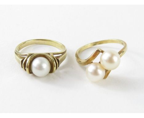 A cultured pearl two stone twist ring, the pearls approximately 6.5mm and 6.7mm, marked 'K14', finger size M, 3g gross; and a