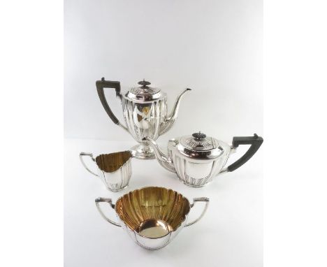 A four piece matched silver tea and coffee service, maker HW, Sheffield 1906, cream jug 1907, of oval outline with fluting, a