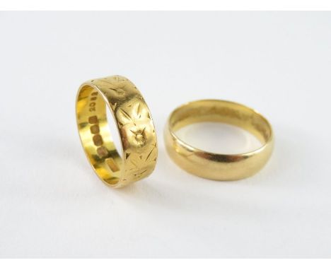 An 18ct gold patterned wedding band, 6mm, finger size L 1/2 and another plain 18ct gold wedding band, 5.5mm wide, finger size