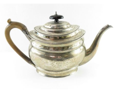 A Georgian silver teapot, SH, London 1802, of oval outline, prick dot decoration, wooden handle, 28.5 cm long, 582g (18.7 tro