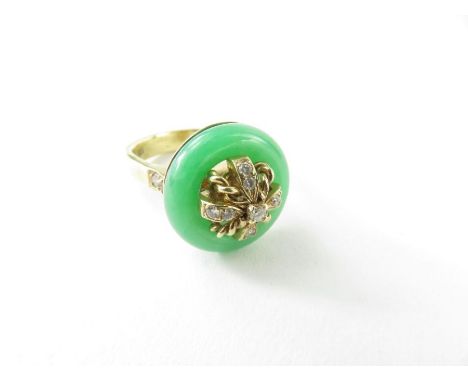 A dyed jadeite and diamond ring, the round pi of jadeite with diamonds to the centre and to each shoulder, marked '14k 585', 