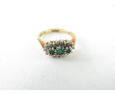 A 9ct gold emerald and diamond cluster ring, the three emeralds surrounded by eighteen round diamonds, claw set, finger size 