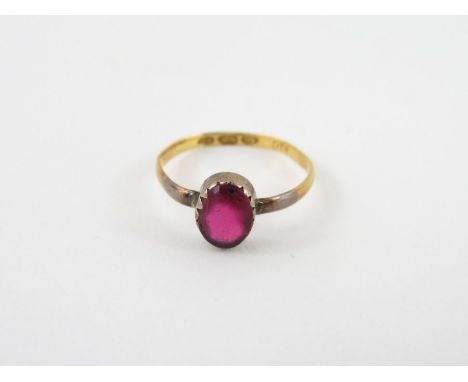 A cabochon set ring, bears marks, tests as 18-22ct gold, finger size M, 1.5g gross
