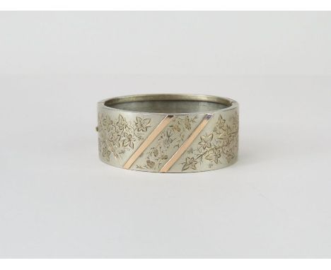 A late Victorian hinged bangle, stamped ‘Sterling’, circa 1880, inner diameter approximately 5.7 cm
