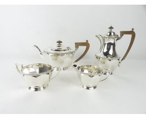 A matched four piece silver tea service, makers mark RS, Glasgow 1930, the hot water jug, GH, Sheffield 1930, of panelled for