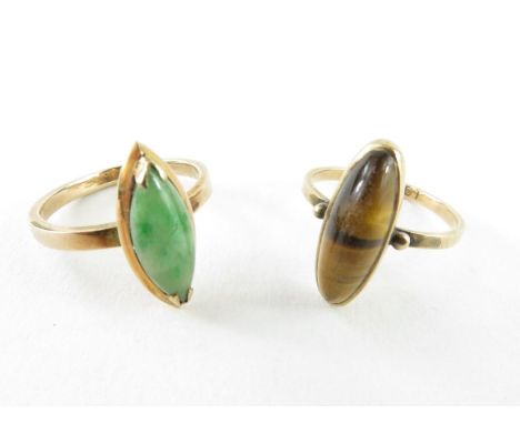A tiger's eye ring, the slim oval stone approximately 16.7mm x 6mm, marked '9ct', finger size N 1/2, 2.58g gross; and a navet