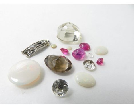 A collection of loose natural and synthetic gemstones to include opal, ruby, quartz and others