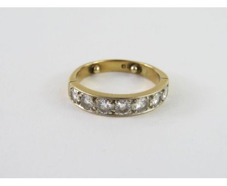 An 18ct gold diamond half eternity ring, set with seven round brilliant cut diamonds, each approximately 3mm, hallmark obscur