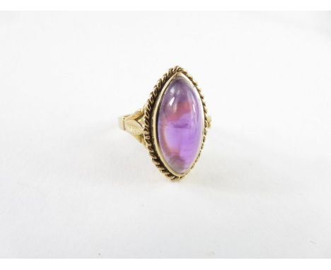 A 9ct gold amethyst dress ring, the navette shaped cabochon cut amethyst approximately 17.3mm x 8.3mm, finger size M 1/2, 5.3