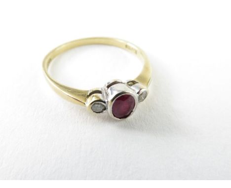 A 9ct gold ruby and diamond three stone ring, the oval ruby approximately 4.7mm x 3.4mm, the round brilliant cut diamonds eac