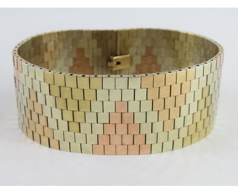 A 9ct yellow, rose and white gold bracelet, formed from tile shaped links, 2.7cm wide, tongue and box catch, 18.5cm long, 68.