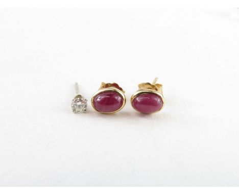 A pair of ruby cabochon cut stud earrings, the oval stones approximately 5.7mm x 4mm, marked '14k', 0.92g gross; together wit