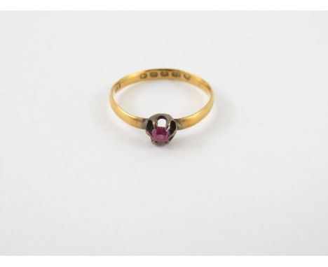 A ruby set 22 carat gold ring, the stone approximately 3mm x 2.5mm, finger size M, 1.5g gross
