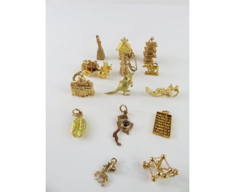 A collection of loose charms - four charms including an abacus and the statue of liberty, all marked '14k', 9.63g gross; four