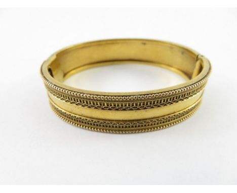 A Victorian hinged gold bangle, unmarked, circa 1880, tests as 9-18ct gold, inner diameter 5.5cm, 15g gross