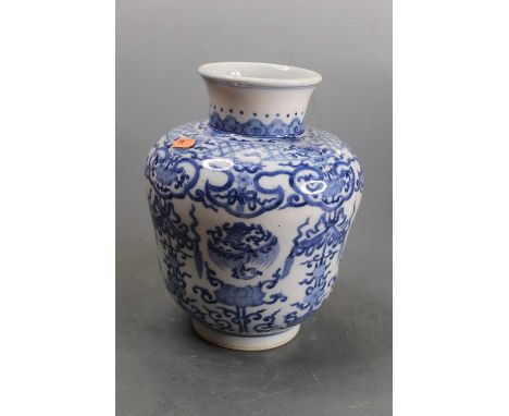 A Chinese export blue and white vase, the everted rim above a waisted body, decorated with birds amongst lotus, four characte