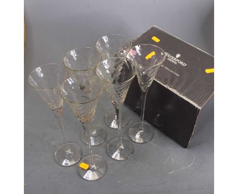 A Waterford Crystal vase, h.25cm, boxed; together with a set of Wrythen moulded glass flutes, h.28cm 