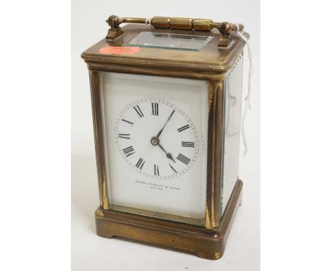 A lacquered brass cased carriage clock, having enamelled dial with Roman numerals, signed Depree Raeburn &amp; Young of Exete