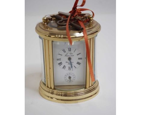 A French lacquered brass cased carriage clock, of barrel form, having enamelled dial with Roman numerals and subsidiary secon