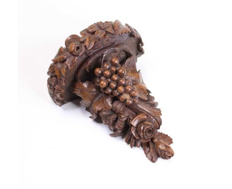 An early 20th century beech wall bracket, carved with various fruiting vines and berries, height 20cm